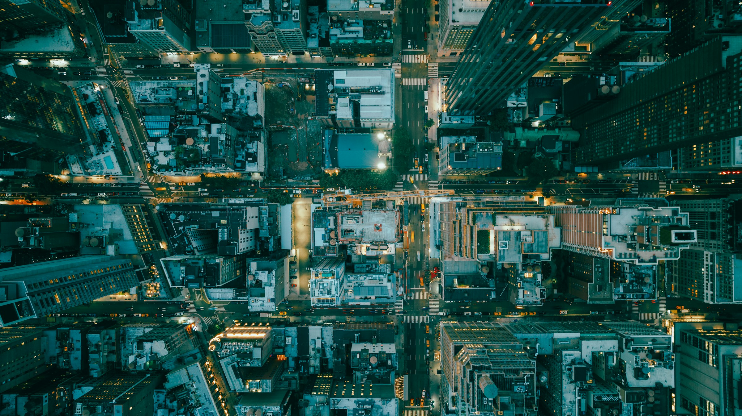 An illuminated city grid seen from above at night